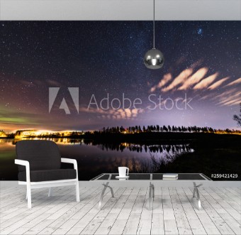 Picture of Starting weak Aurora at almost clear skies tiny clouds like feathers above lake at Scandinavian countryside